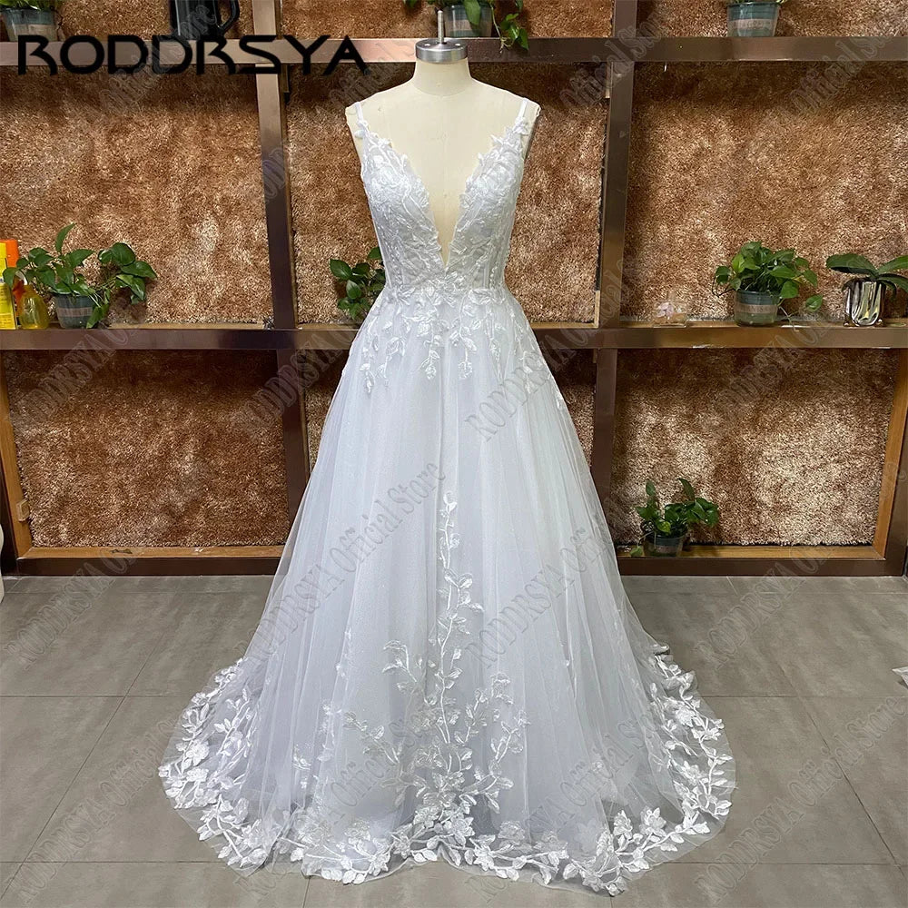 Glitter spaghetti straps wedding dress with V-neck, backless design, appliqué details, and sweeping train by The Clothing Company Sydney