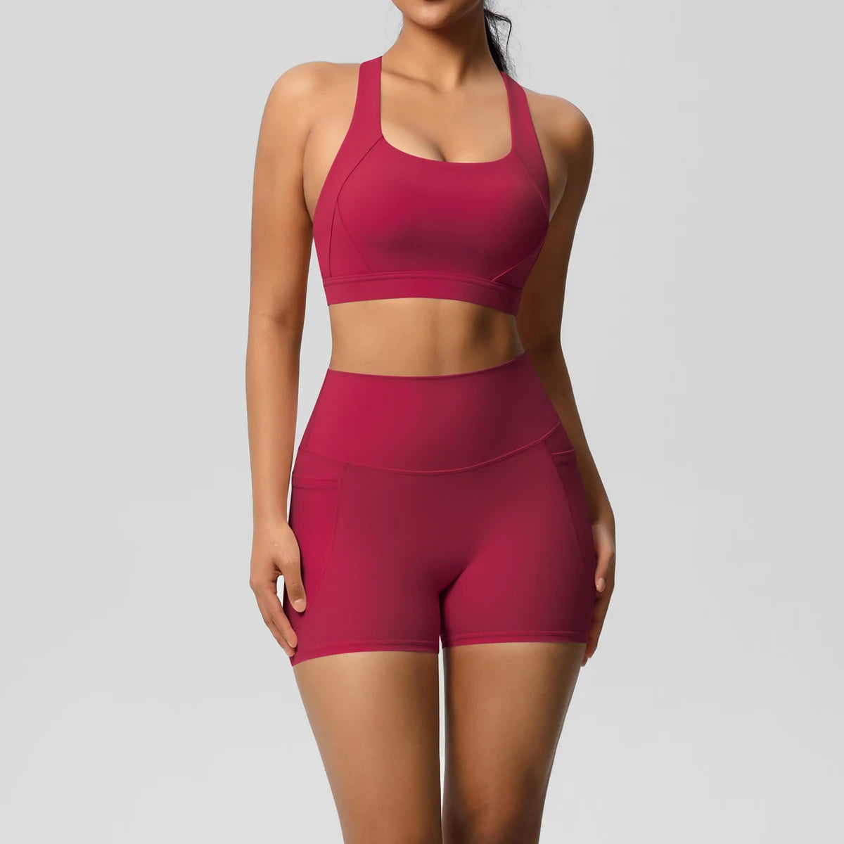 The Clothing Company Sydney women's 2-piece sportswear yoga set with crossover bra, pocketed gym shorts, and leggings for fitness activities.