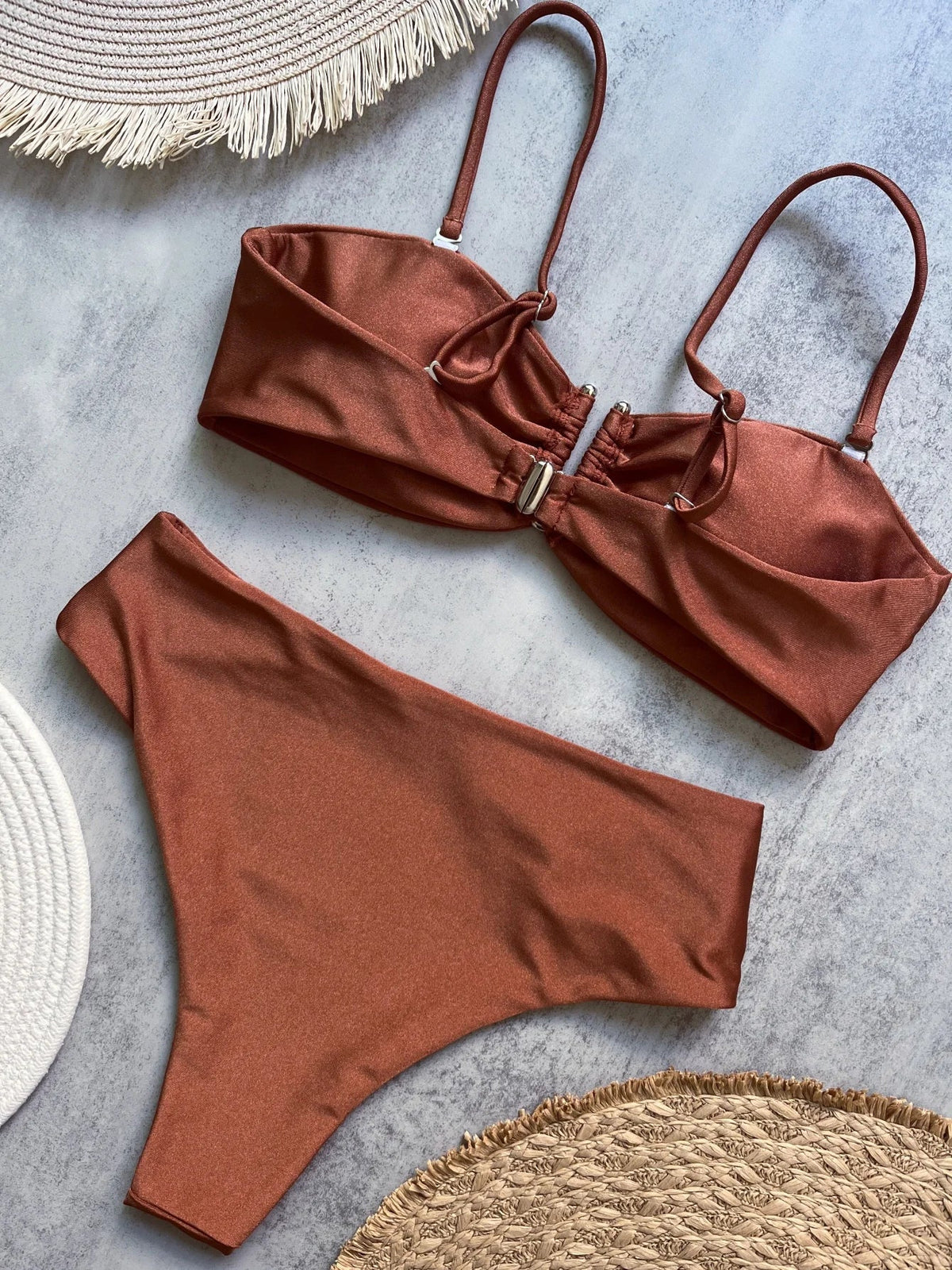 Two-piece bandeau bikini with push-up top from The Clothing Company Sydney, solid Brazilian swimsuit set with thong bottoms on a beach.