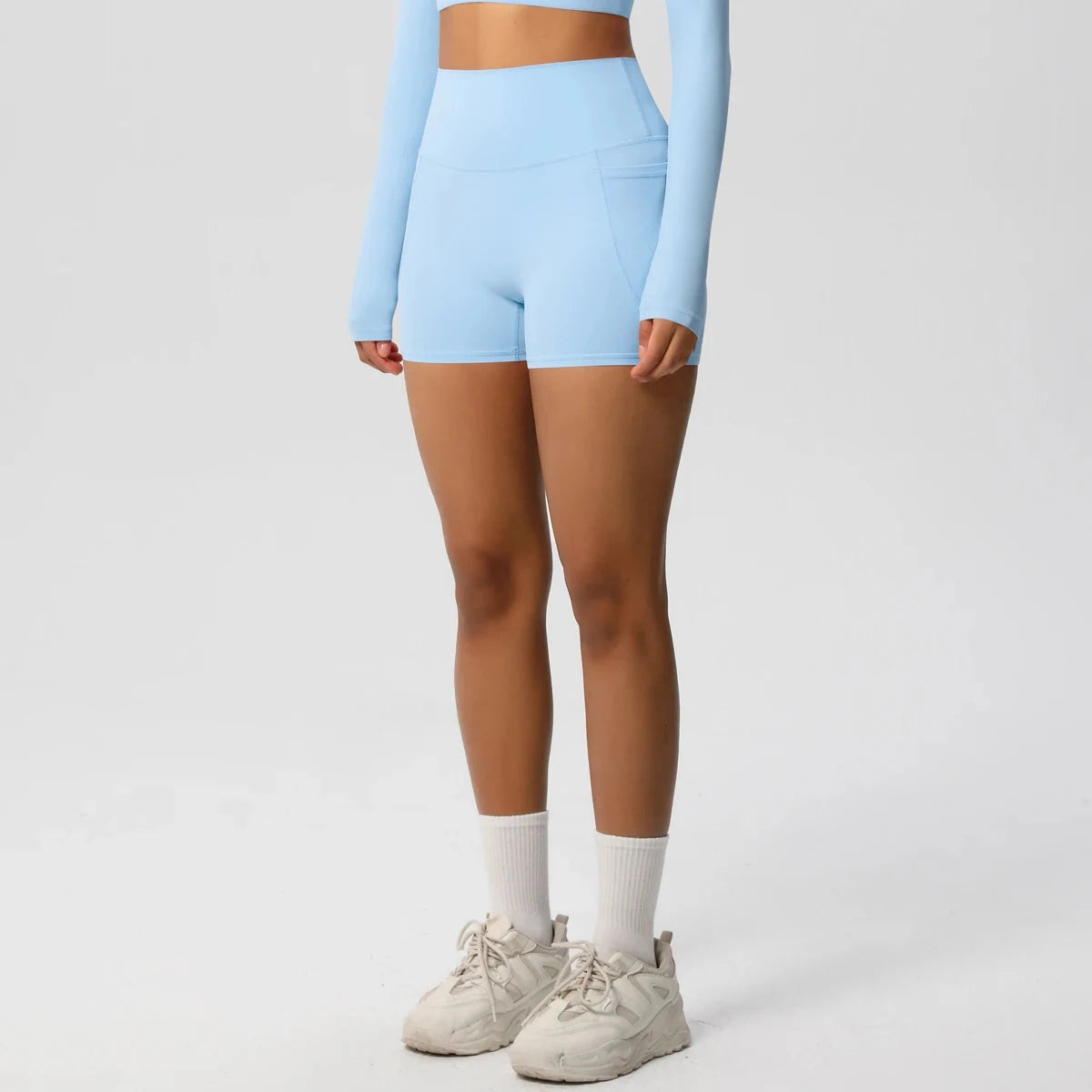 Women's high-waisted bicycle yoga pants with pockets, quick-drying, breathable gym shorts for fitness and workout activities.