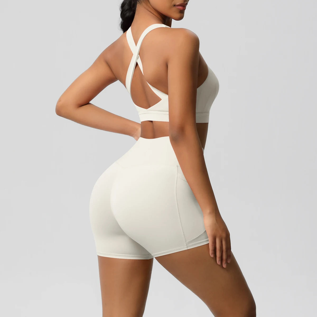 Women's fitness yoga set with crossover sports bra and pocketed gym shorts, includes yoga leggings and bike shorts from The Clothing Company Sydney.