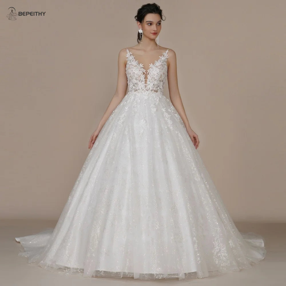 Ivory strapless A-line wedding dress with glitter embellishments and off-the-shoulder design, designed for brides, by The Clothing Company Sydney.