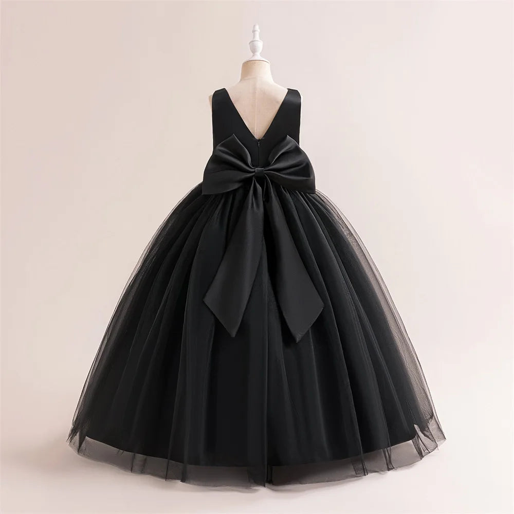 Girls' white bridesmaid and prom gown with a large bow, formal evening dress for weddings, parties, and communions by The Clothing Company Sydney.