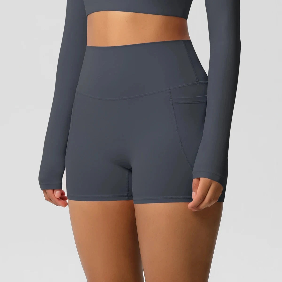 High-waisted bicycle yoga shorts by The Clothing Company Sydney with pockets, quick-drying, breathable fabric for women’s fitness workouts.