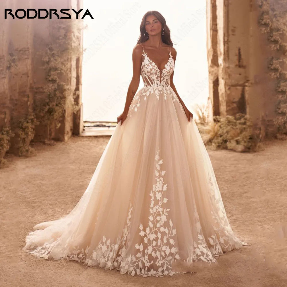Elegant wedding dress by The Clothing Company Sydney featuring spaghetti straps, glitter V-neck, backless design, and sweep train.