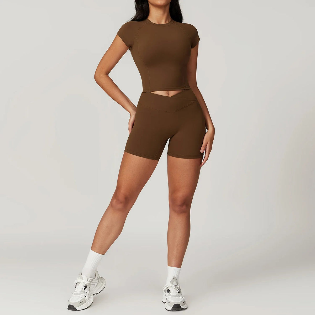 Two-piece women's fitness sportswear set including crop top, sports bra, and gym leggings from The Clothing Company Sydney.