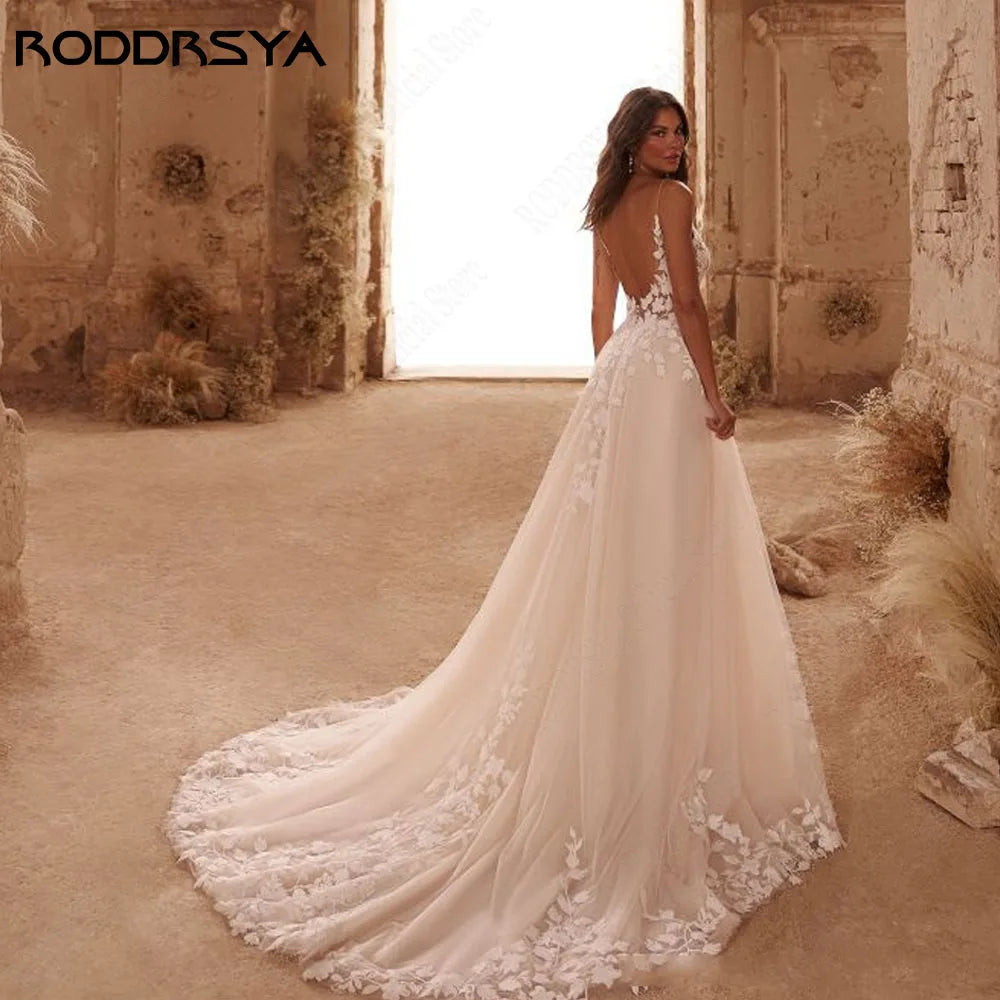 Sparkling boho wedding dress with spaghetti straps, V-neck, backless design, appliqué embellishments, and sweep train by The Clothing Company Sydney