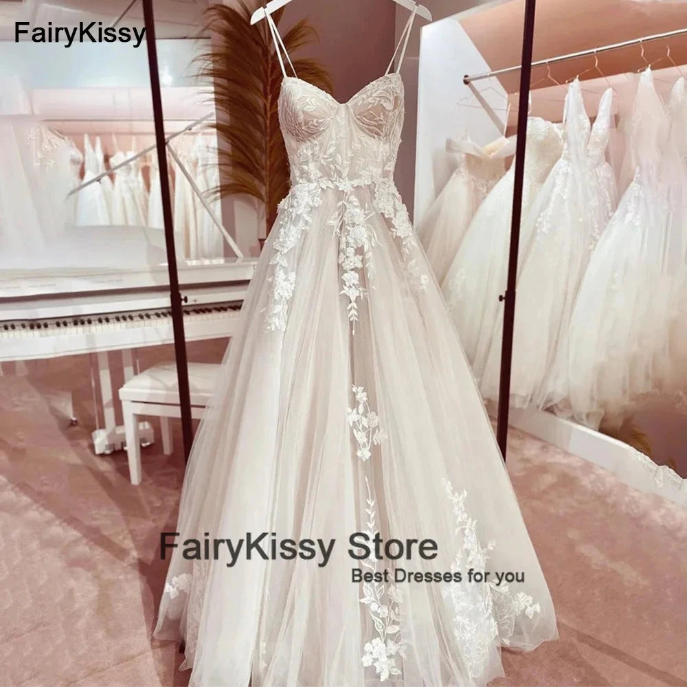 Elegant backless wedding dress by The Clothing Company Sydney featuring spaghetti straps, see-through mesh, lace, and princess silhouette.