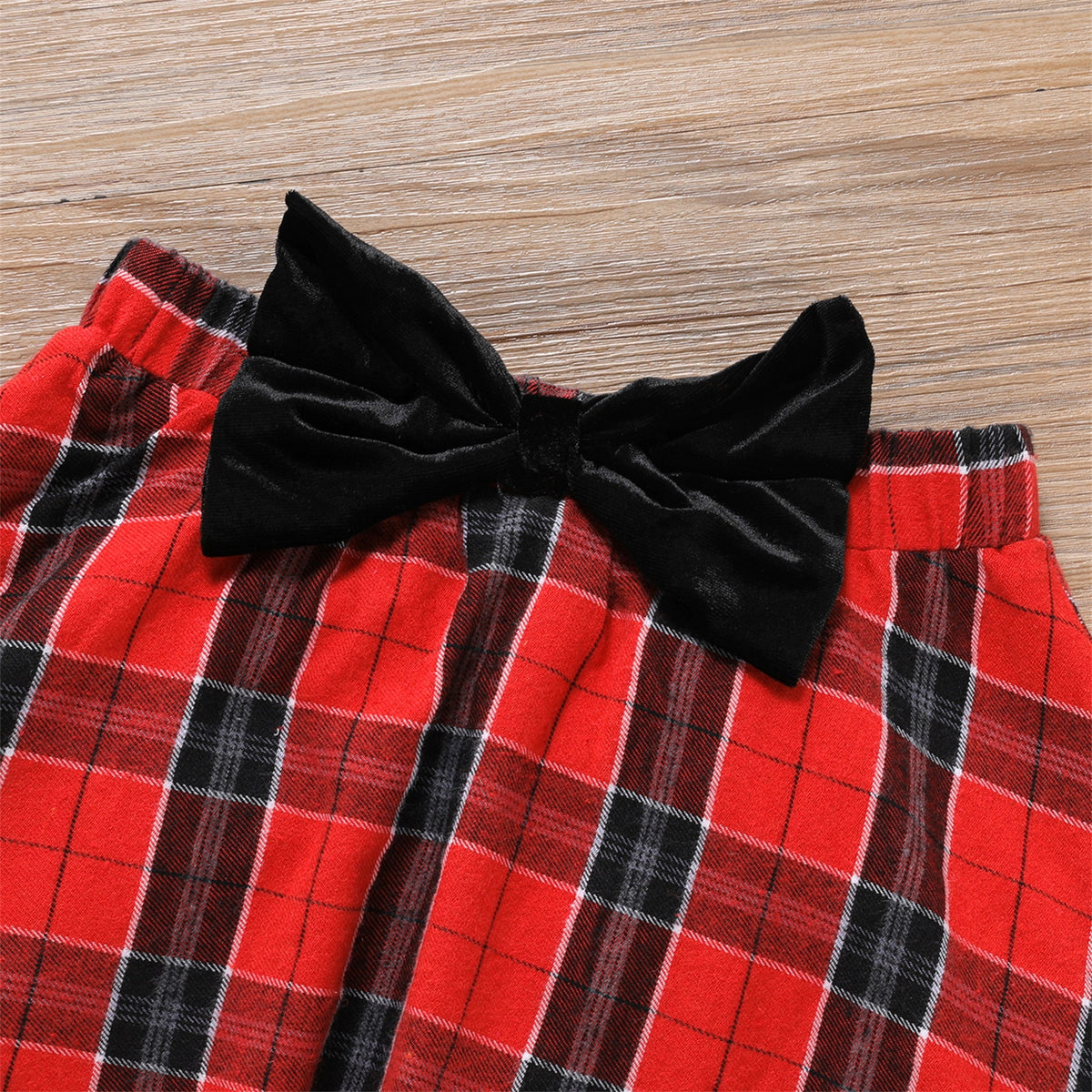 Kids girls' black velvet long-sleeve tee and plaid skirt set with 3D bowknot design, by The Clothing Company Sydney.