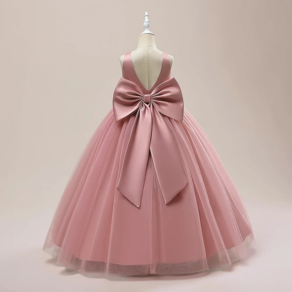 Girls' white bridesmaid and prom gown with a big bow, formal evening dress for special occasions by The Clothing Company Sydney.