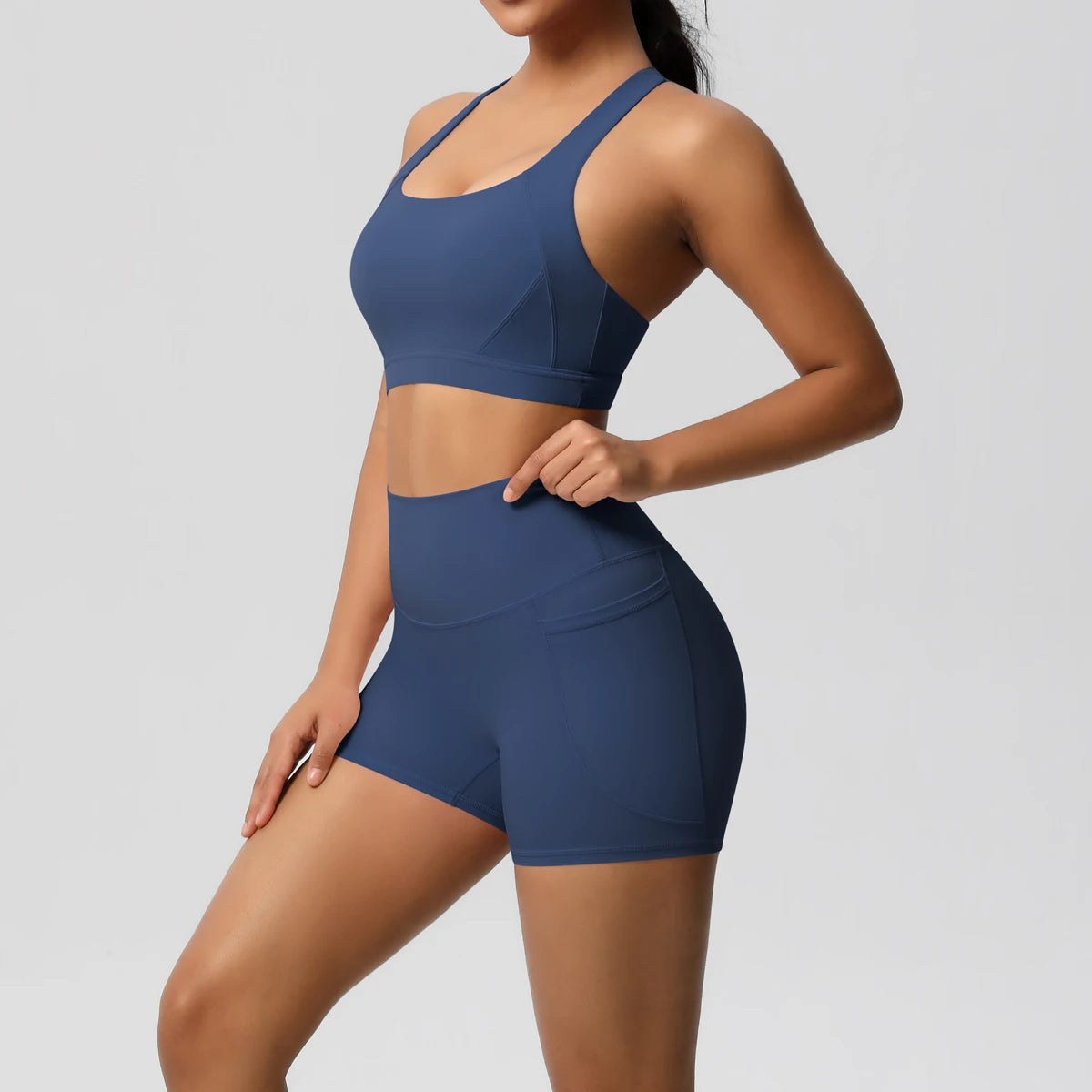 The Clothing Company Sydney women's 2-piece sportswear yoga set with crossover bra, pocketed gym shorts, and matching leggings.