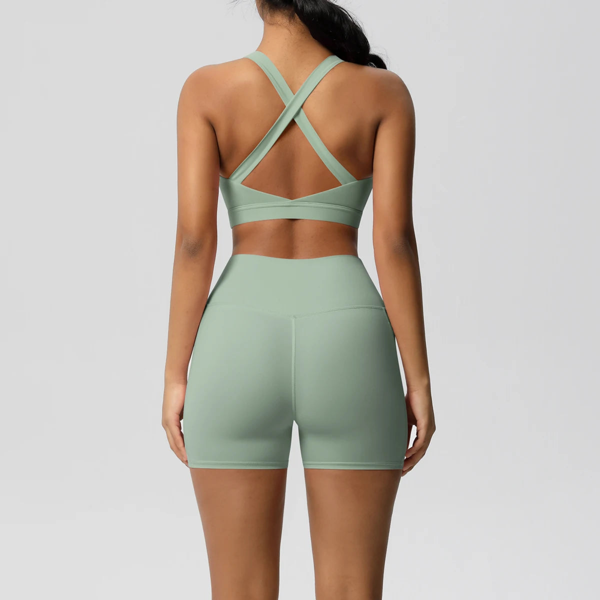 Women's fitness sportswear set with crossover bra, leggings, gym shorts, and pocketed track suits from The Clothing Company Sydney.