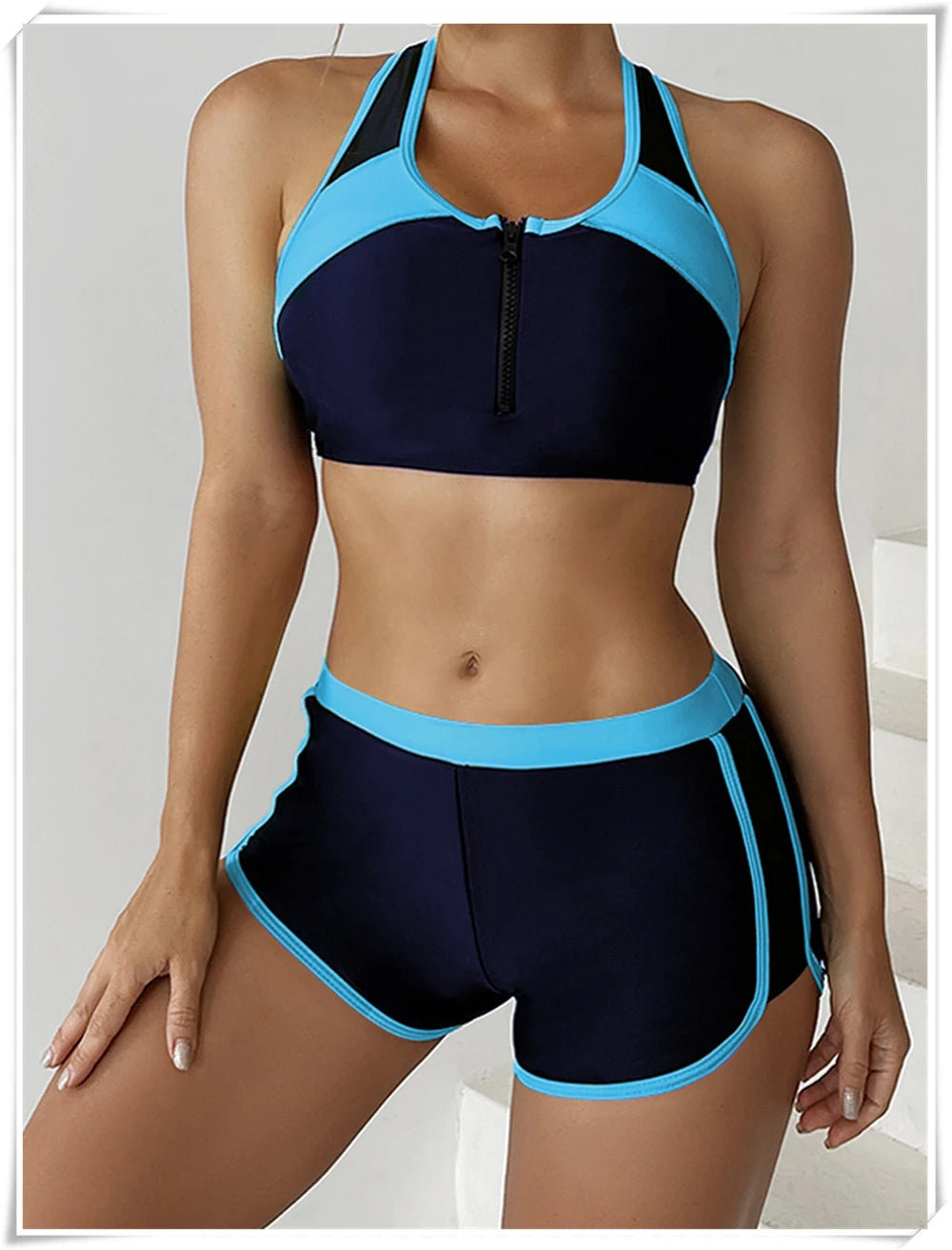 Two-piece swimsuit by The Clothing Company Sydney featuring a zipper tankini top and high-waist swim shorts for summer beachwear.