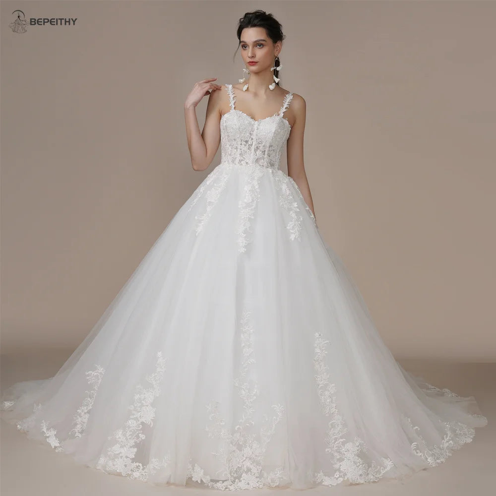 Ivory strapless A-line glitter wedding dress with off-the-shoulder design and bling embellishments, by The Clothing Company Sydney.