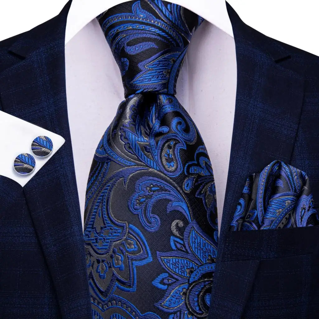 Blue paisley silk tie set for men includes necktie, cufflinks, and pocket hanky, features elegant pattern and accessories.