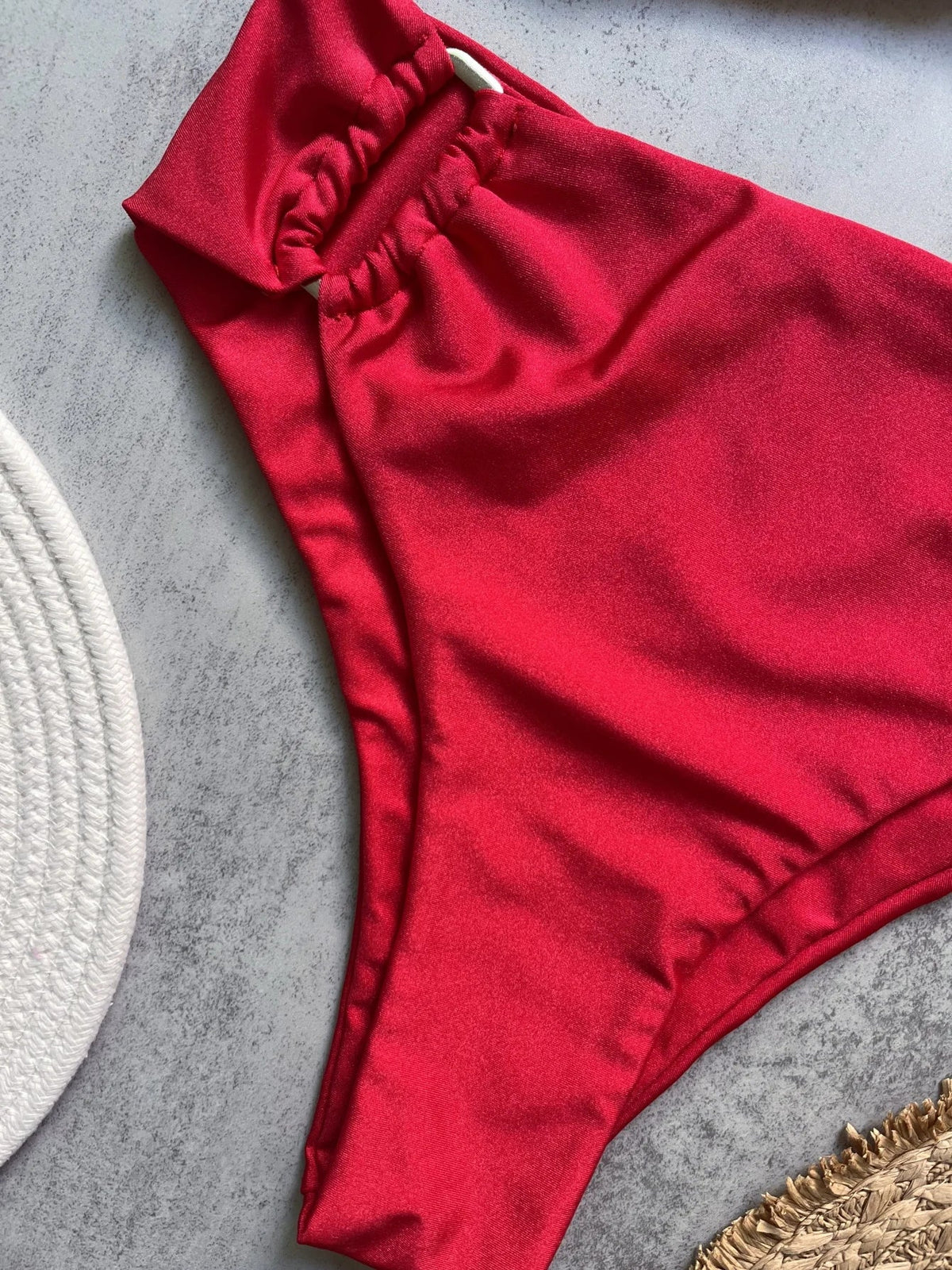 Two-piece bandeau bikini set by The Clothing Company Sydney featuring push-up style, solid color, Brazilian thong swimwear on the beach