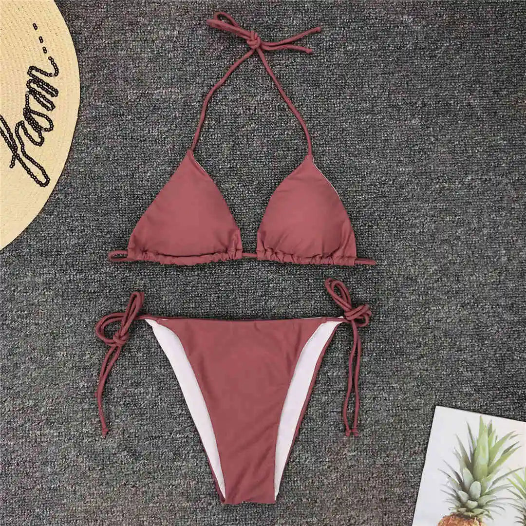 Neon pink Brazilian bikini set for women, halter style two-piece swimwear from The Clothing Company Sydney, shown on a model.