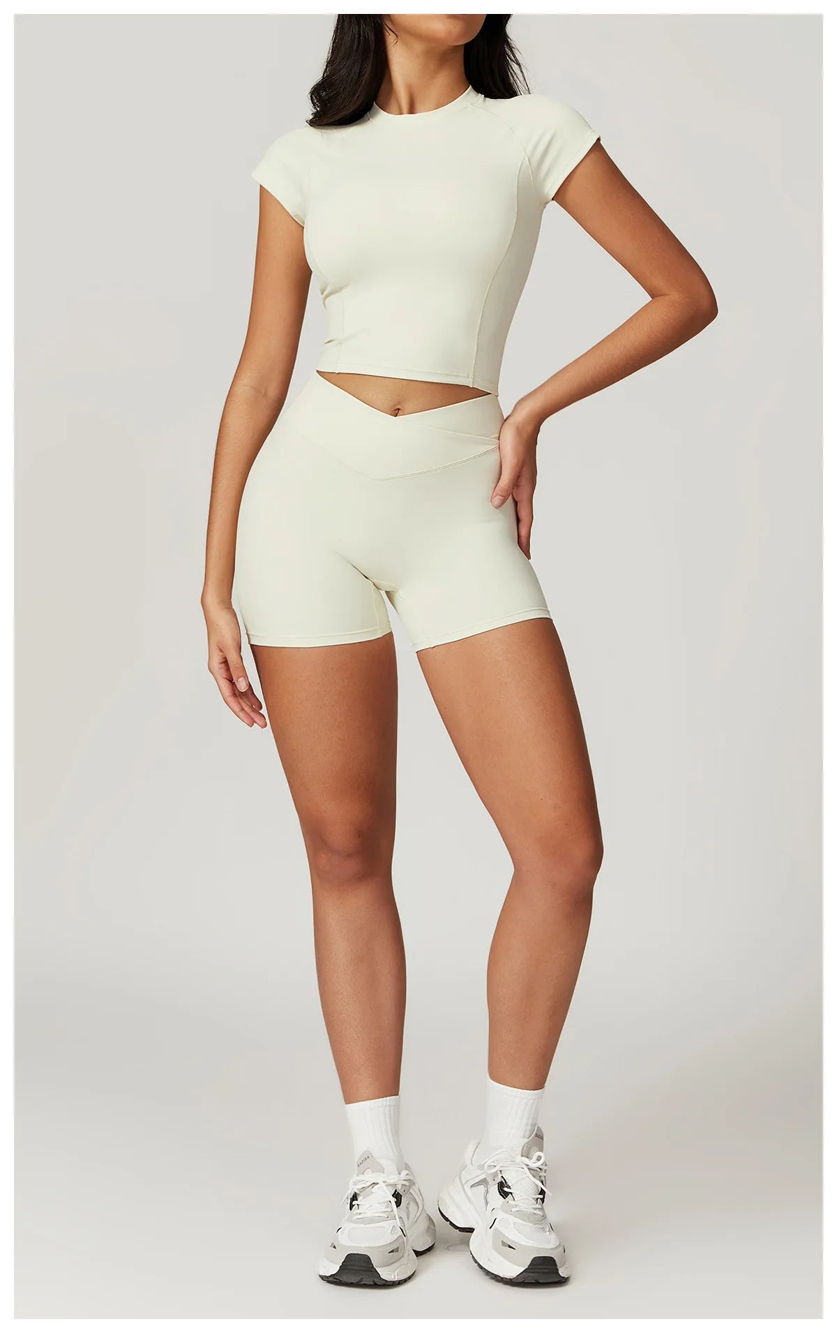 Two-piece women's fitness set including a short sleeve crop top, sports bra, and leggings from The Clothing Company Sydney.