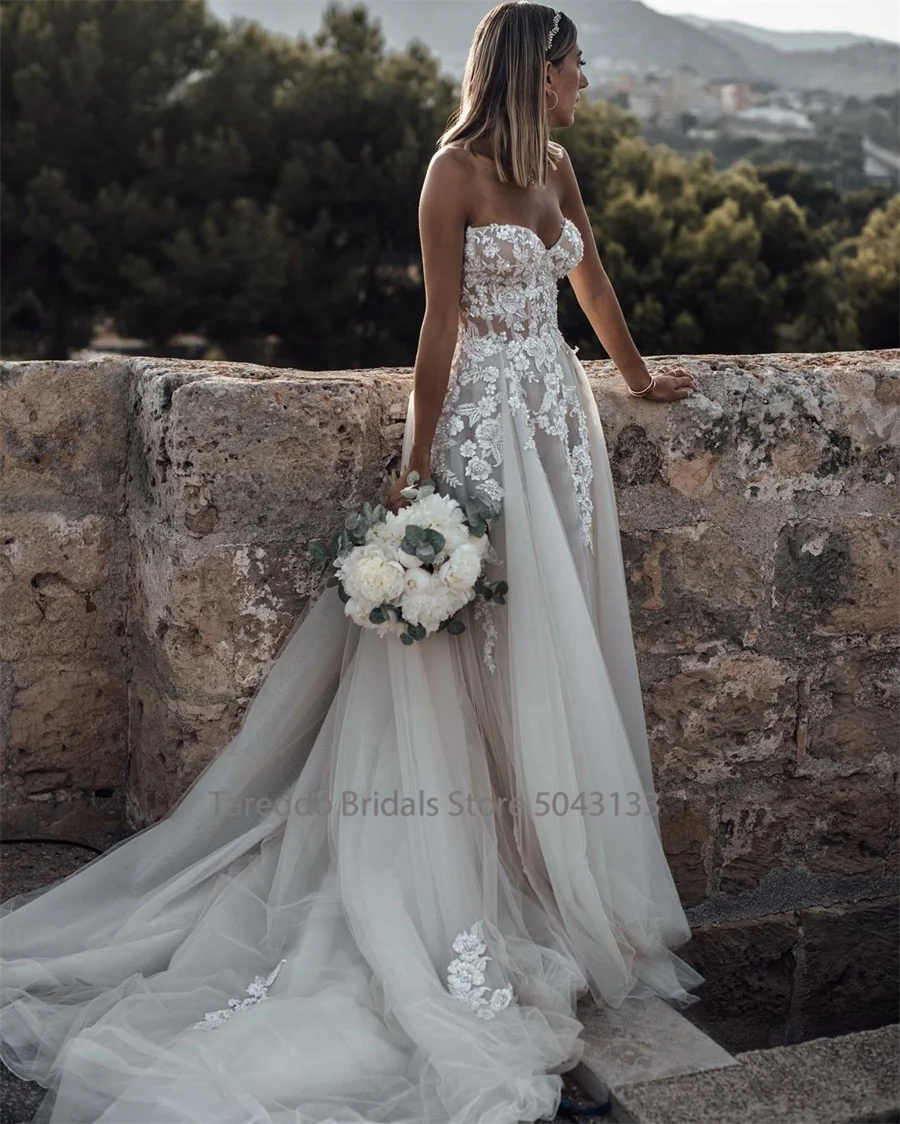 Strapless wedding dress with crystal lace appliques, flowing silhouette, from The Clothing Company Sydney, elegant bridal gown image