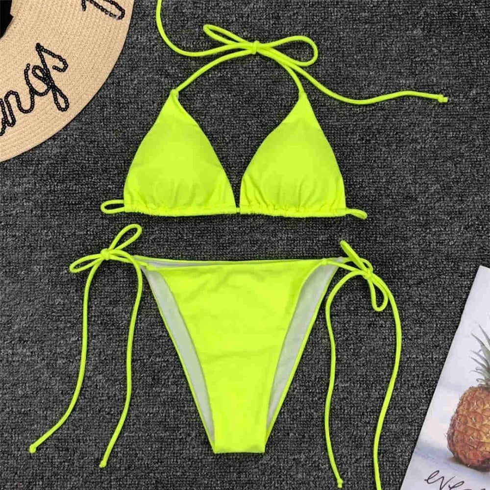 Neon pink Brazilian bikini set by The Clothing Company Sydney featuring a halter top and matching bikini bottoms for women.