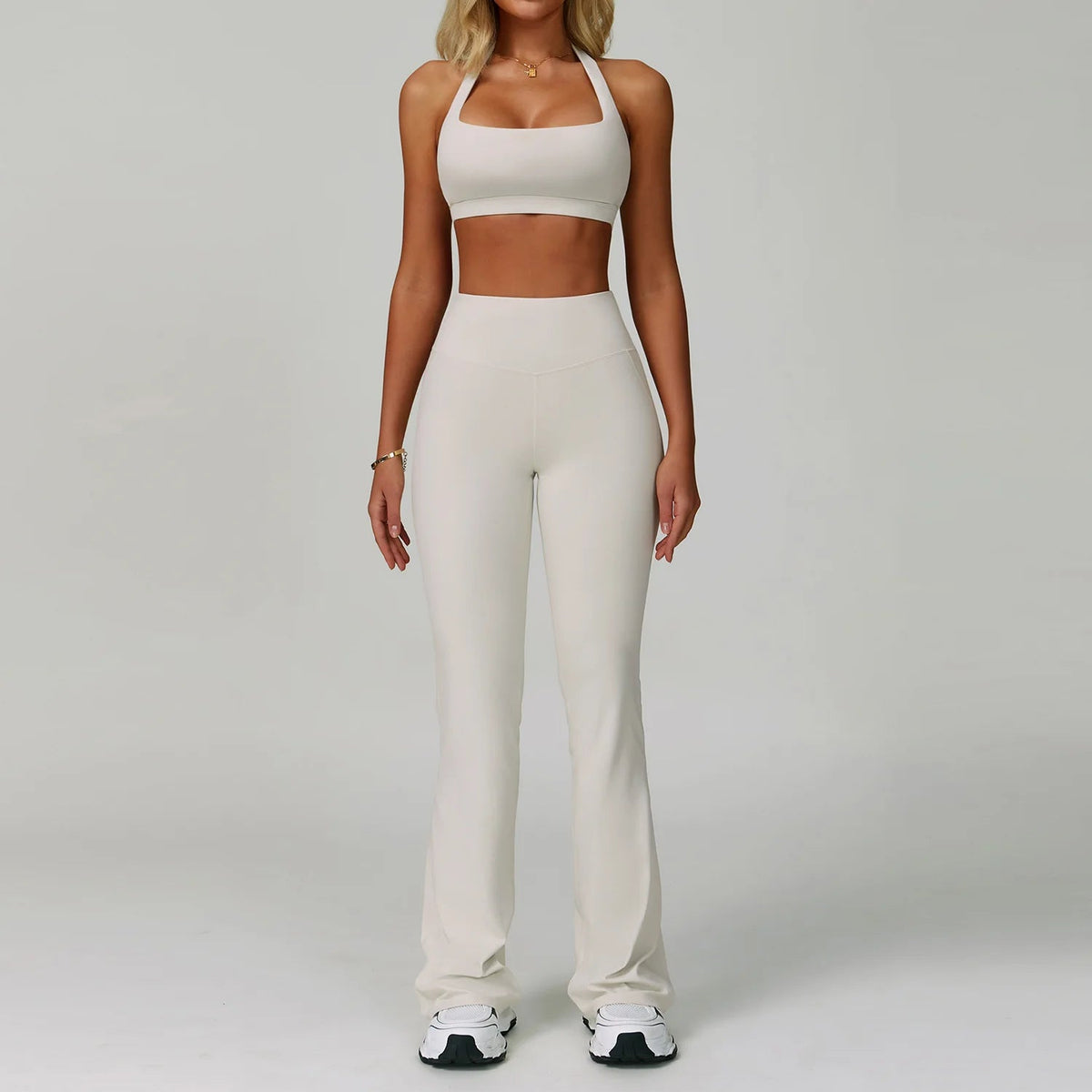Two-piece women's fitness tracksuit with high-waist leggings and sports bra, perfect for yoga, workouts, and gym activities.