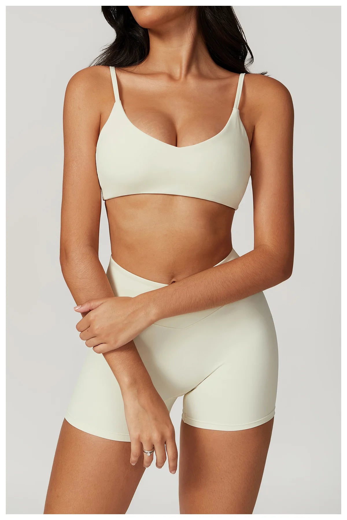 Two-piece women's fitness sportswear set including a short sleeve crop top, sports bra, and leggings for gym and yoga activities.