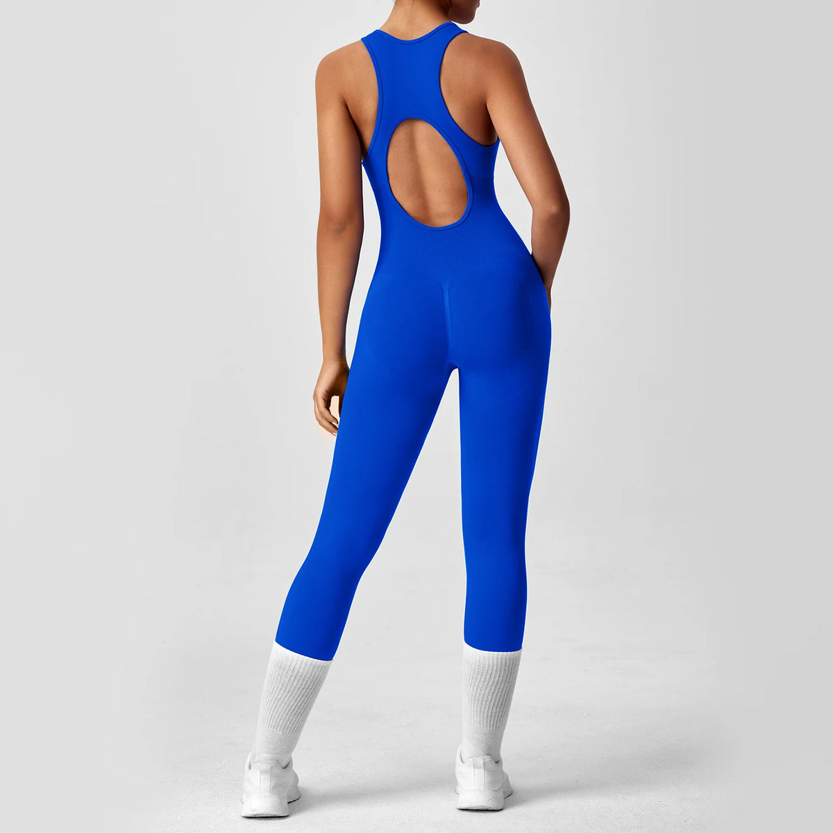 Seamless peach-colored booty one-piece yoga bodysuit by The Clothing Company Sydney, showing V-back design for women’s fitness workout.