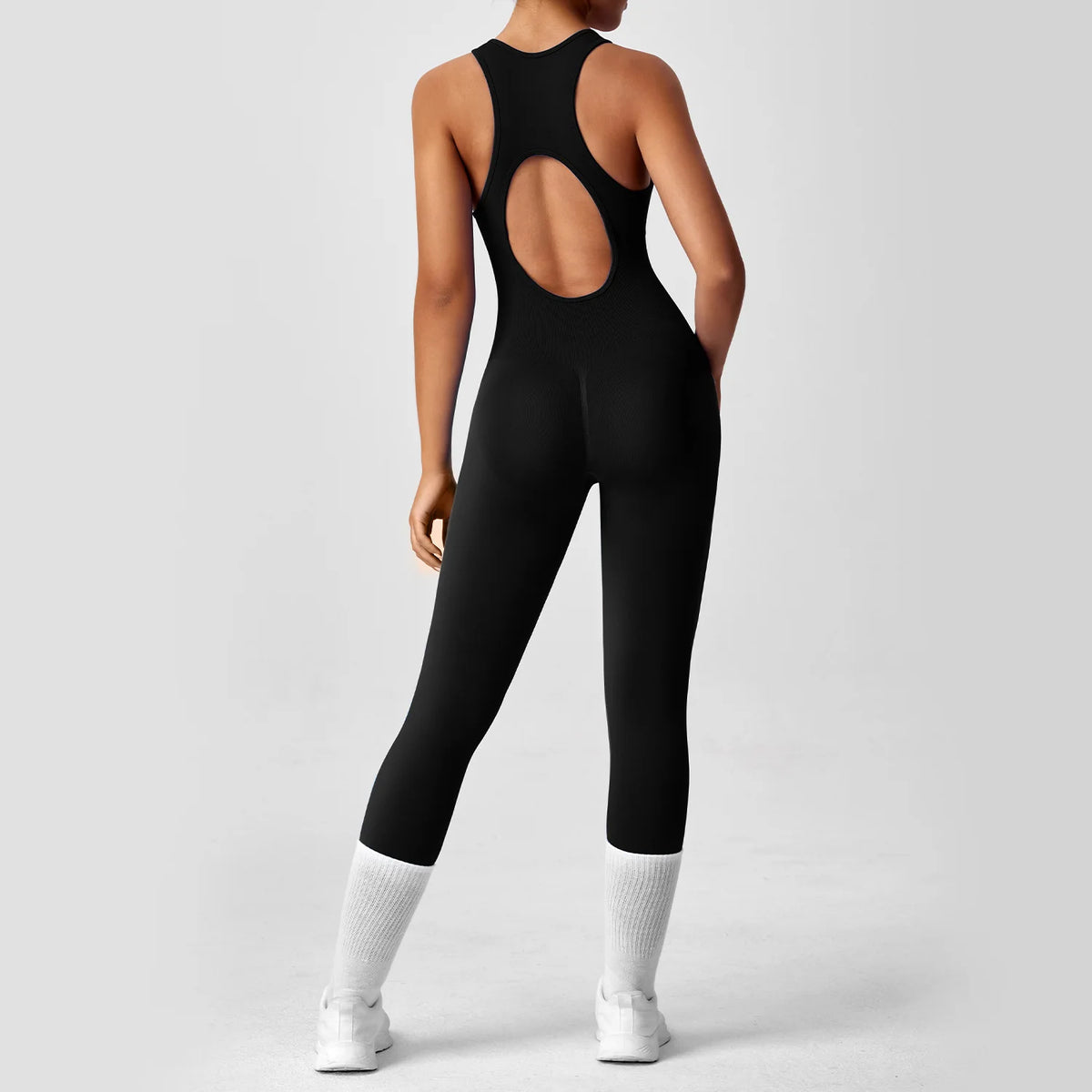 Seamless peach-colored one-piece yoga bodysuit with V-back design, fitness activewear for women, by The Clothing Company Sydney.