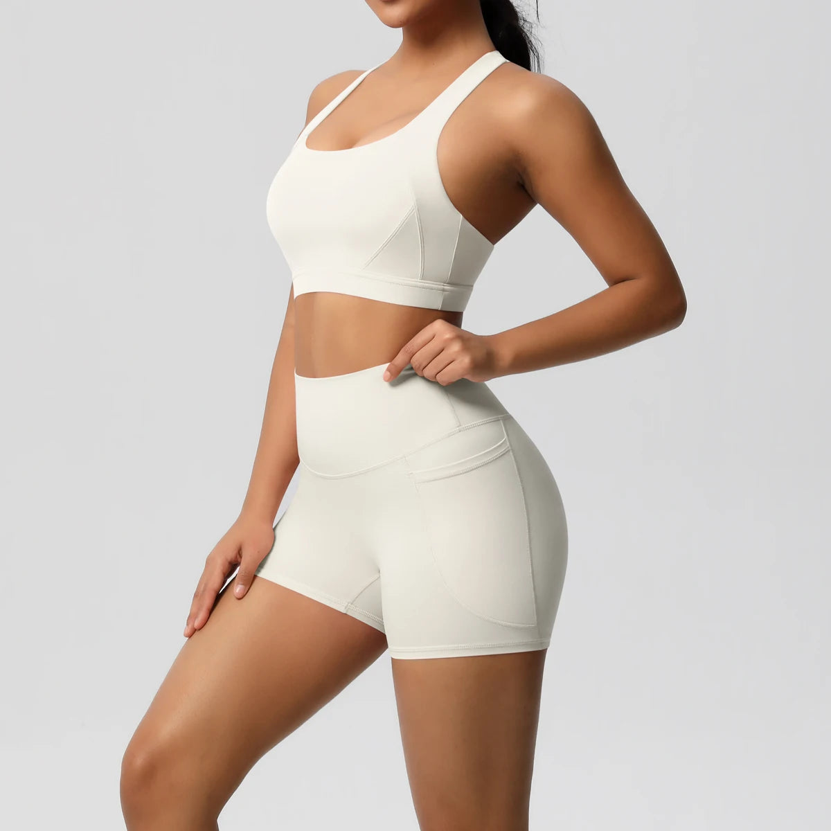 Fitness sportswear set with pocketed gym clothes, yoga suits, shorts, crossover bra, and leggings for women by The Clothing Company Sydney.