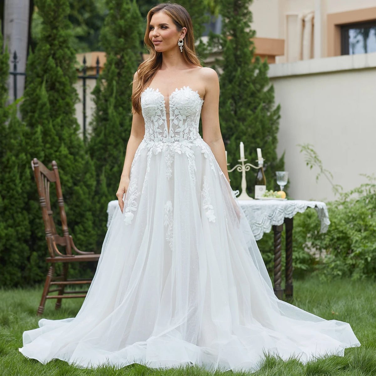 Elegant sleeveless lace wedding dress with deep V-neck and sparkly accents, designed by The Clothing Company Sydney.