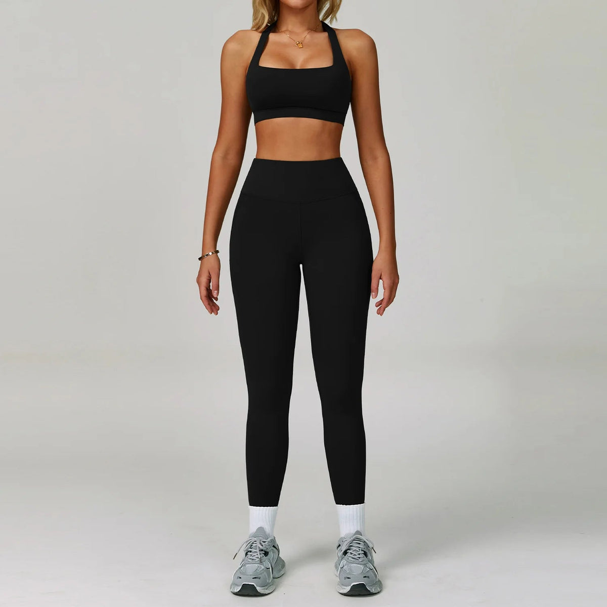 Two-piece women's fitness tracksuit including a sports bra and high-waist leggings from The Clothing Company Sydney, designed for yoga and workouts.