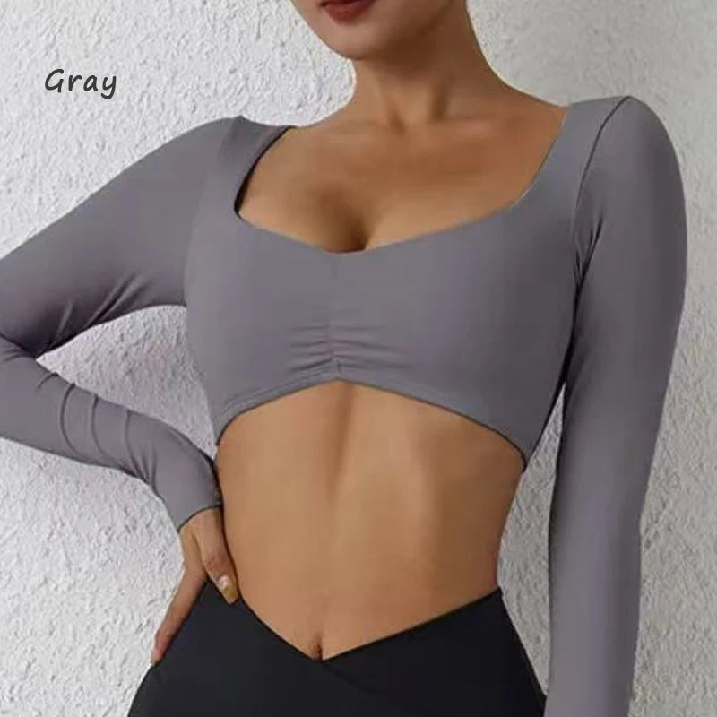 Nylon gym yoga long sleeve T-shirt with pleats, fitted waist, and athletic fit for women's fitness and yoga activities.