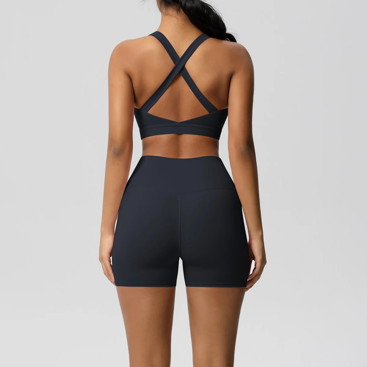 Women's fitness sportswear set with gym shorts, crossover bra, and leggings from The Clothing Company Sydney, featuring pockets.