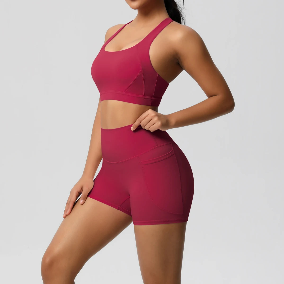 Women’s 2-piece sportswear set with pocketed gym shorts, crossover bra, and leggings by The Clothing Company Sydney.