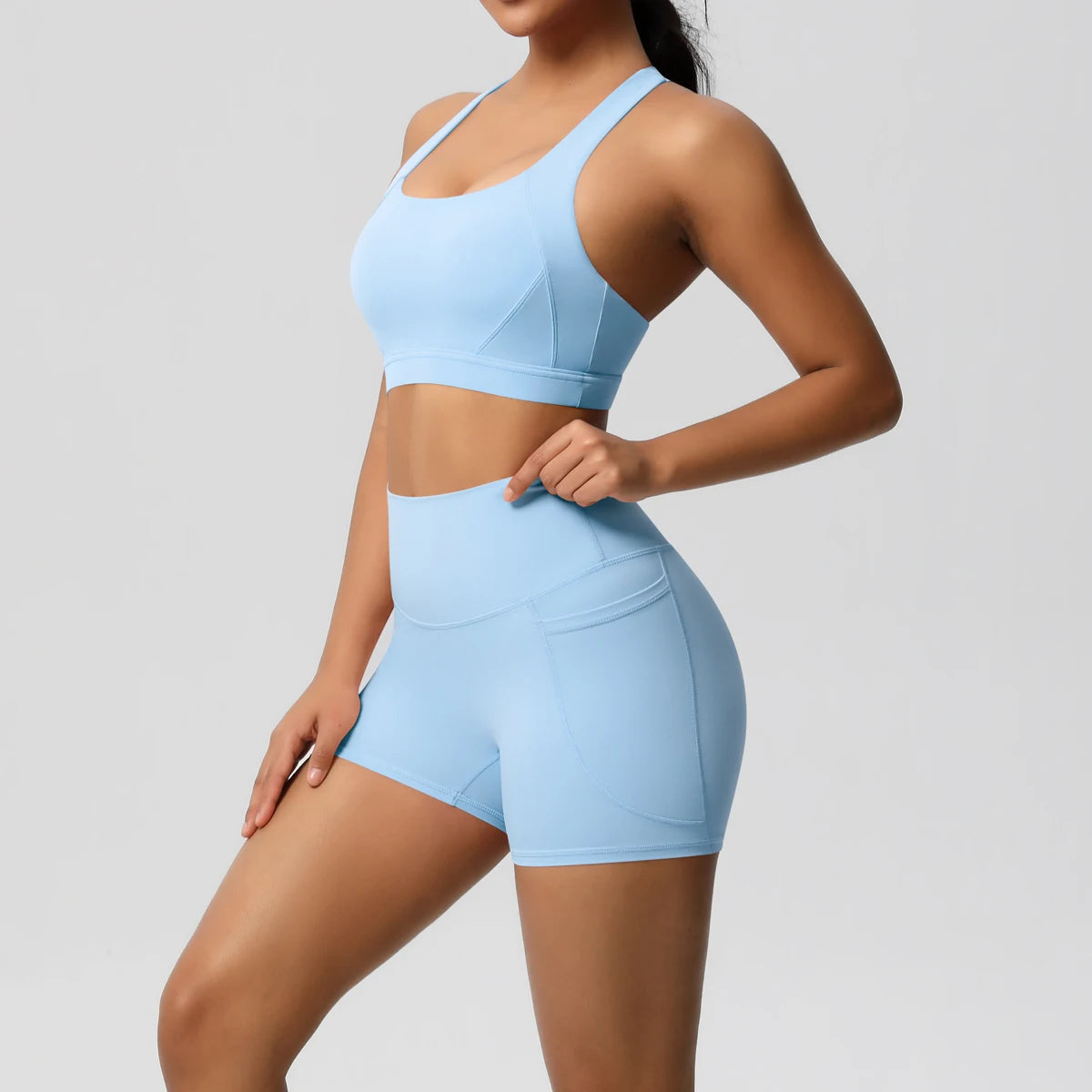 Women’s 2-piece sportswear set with pocketed gym shorts, crossover bra, and leggings by The Clothing Company Sydney.