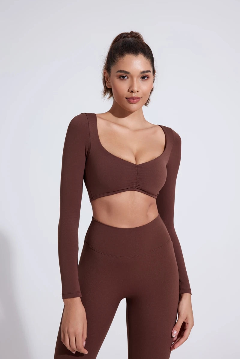 Nylon women's long-sleeve yoga top with pleats and waist fit, suitable for gym and fitness activities, by The Clothing Company Sydney.