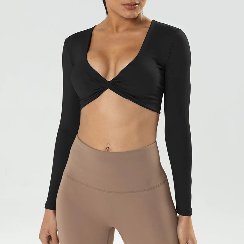 Long sleeve gym crop top by The Clothing Company Sydney featuring twist design, deep V neckline, padded sports fabric, suitable for yoga and fitness.