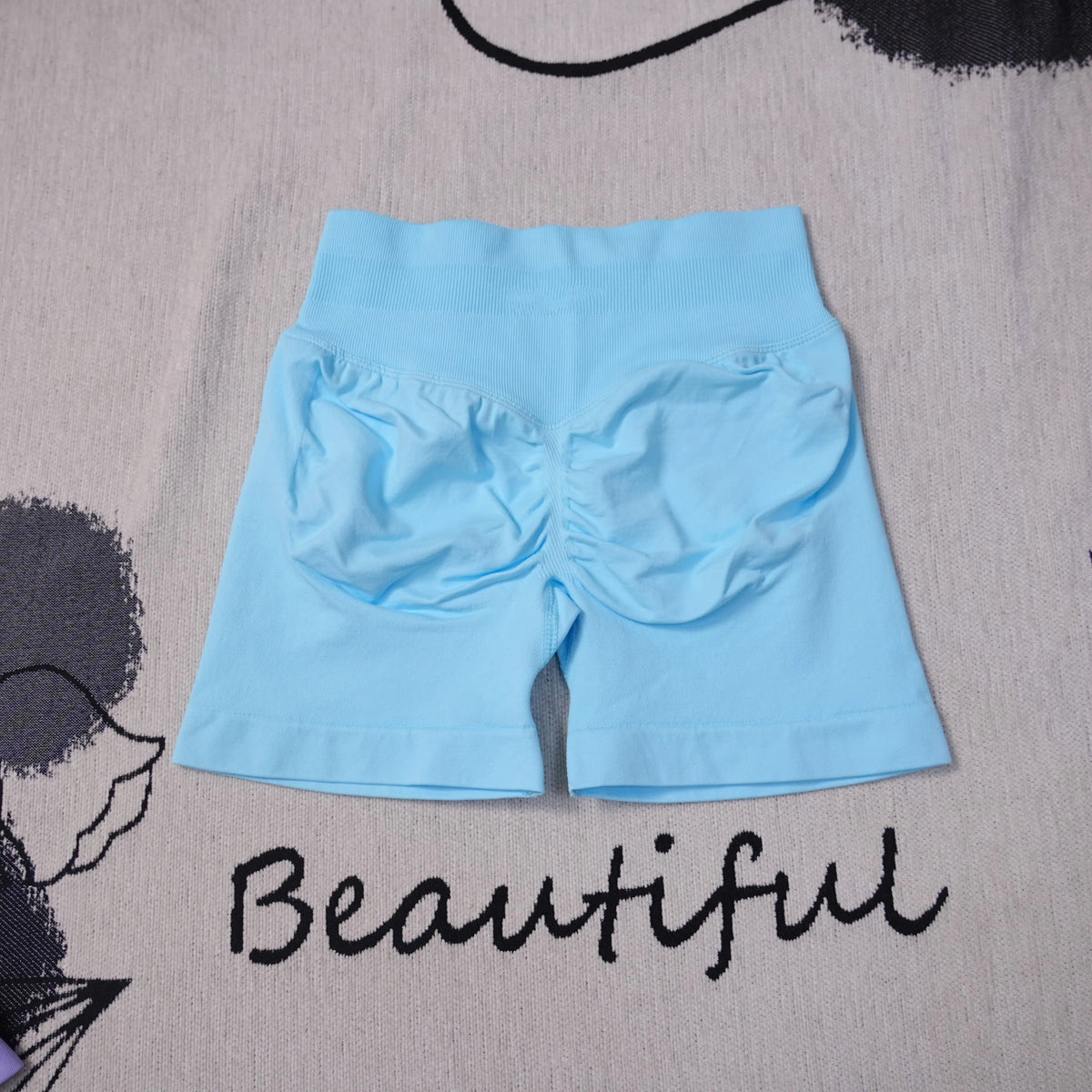 High-waisted women's seamless yoga shorts by The Clothing Company Sydney, featuring breathable, butt-lifting design for workout and gym.