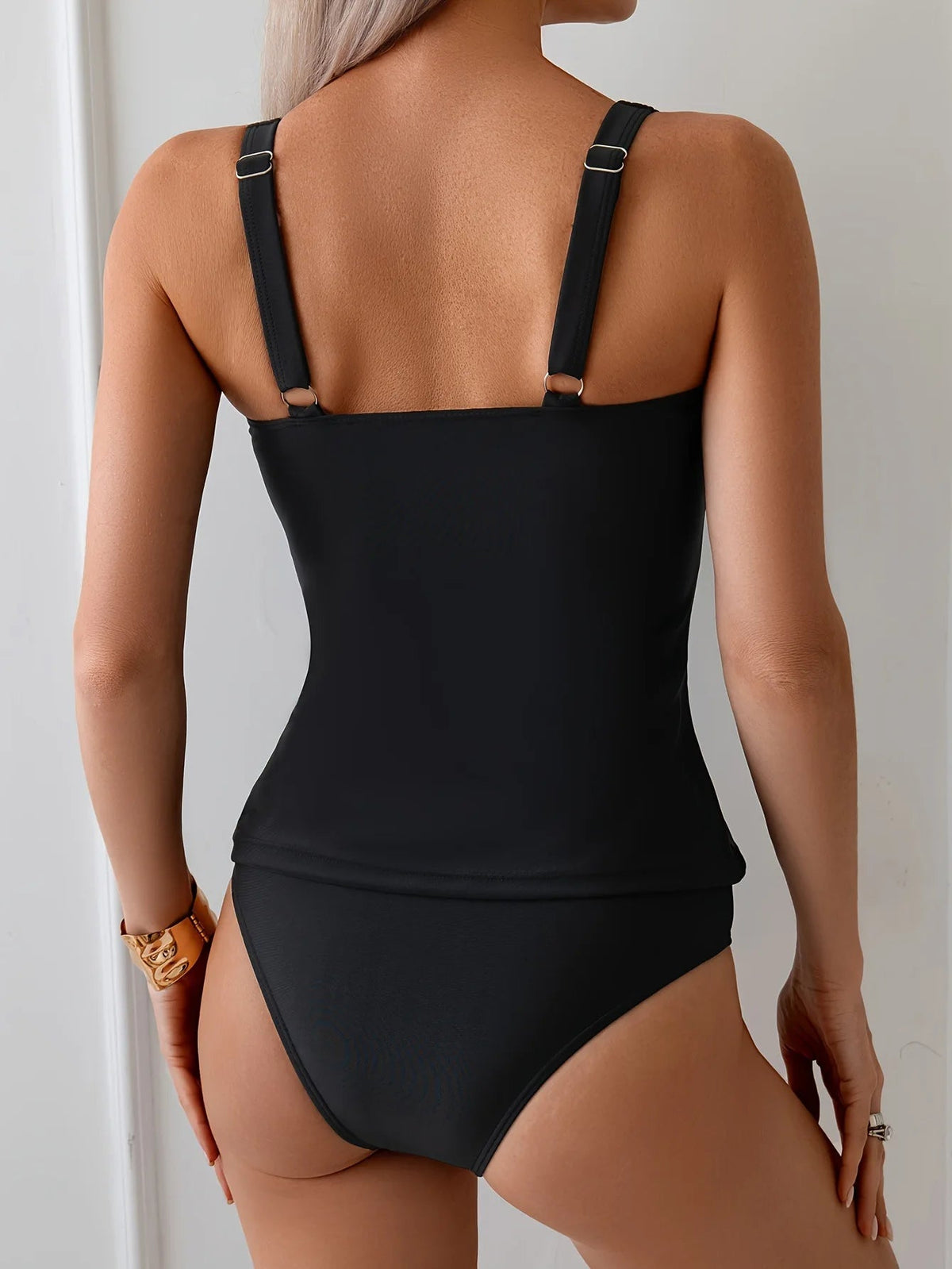 Black two-piece swimsuit with ruffled neckline and straps, perfect for summer beachwear, by The Clothing Company Sydney.