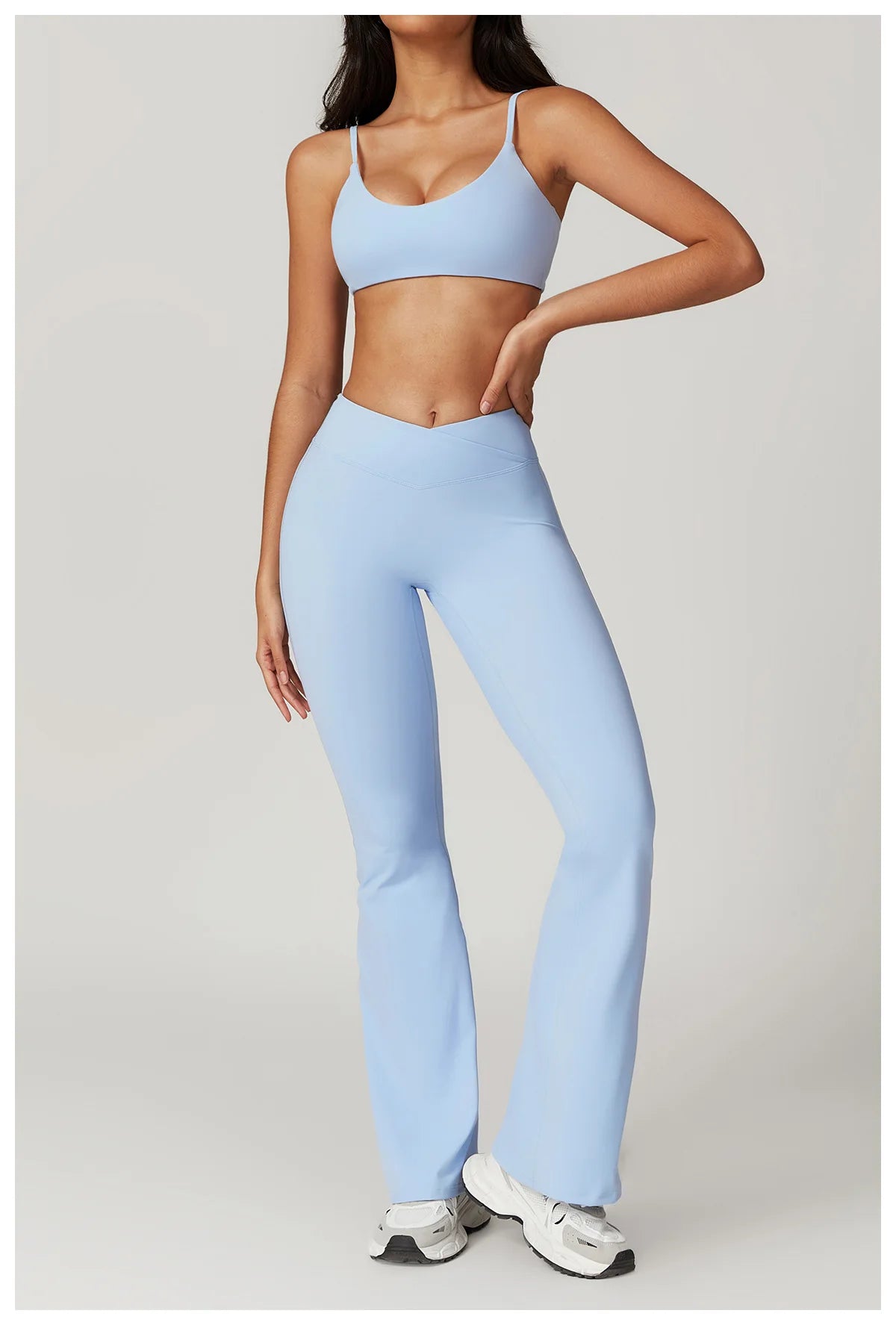 Two-piece women's fitness sportswear set including a crop top, sports bra, and leggings for yoga and gym workouts.