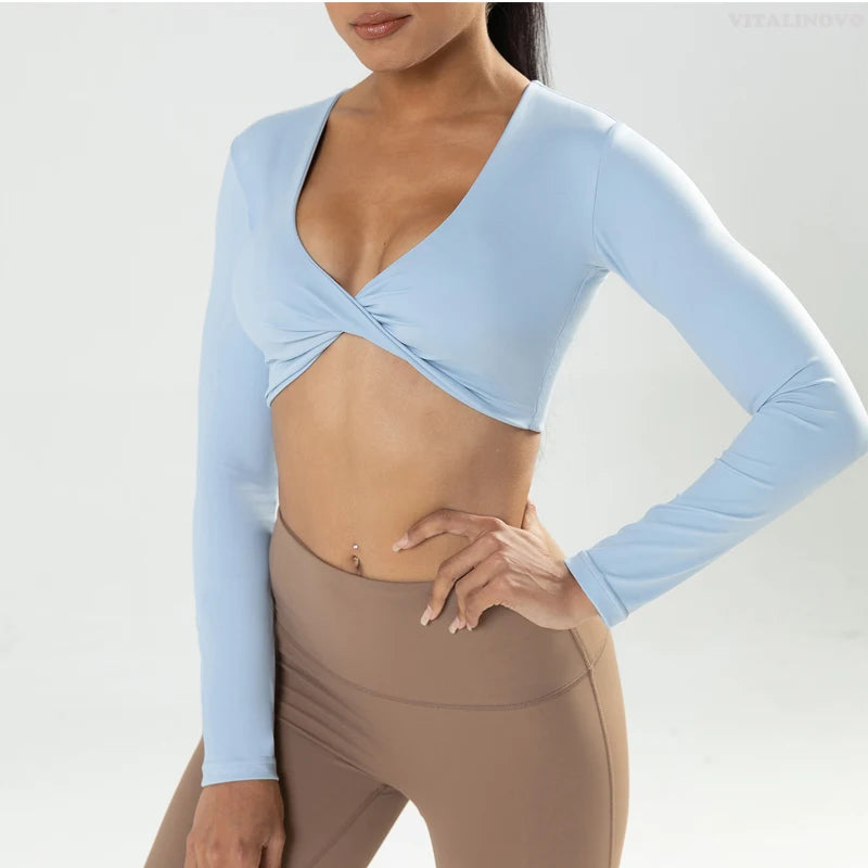 Long sleeve fitness crop top by The Clothing Company Sydney featuring twist design, deep V neckline, padded sports wear for yoga and workouts.