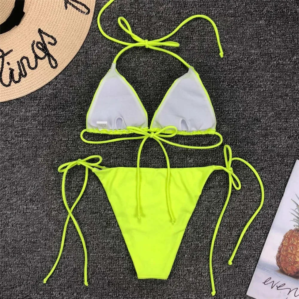 Neon pink Brazilian bikini swimsuit for women, halter style two-piece swimwear with cut-out details, from The Clothing Company Sydney.