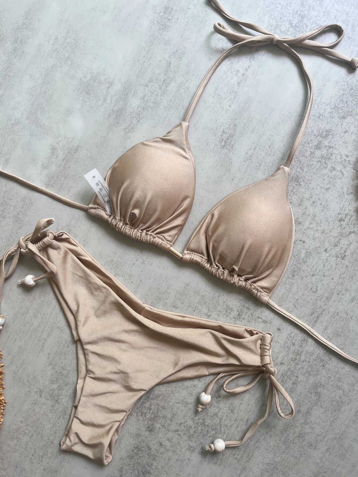 Two-piece micro bikini swimsuit with triangle top and matching bottoms, perfect for beachwear and sunbathing.