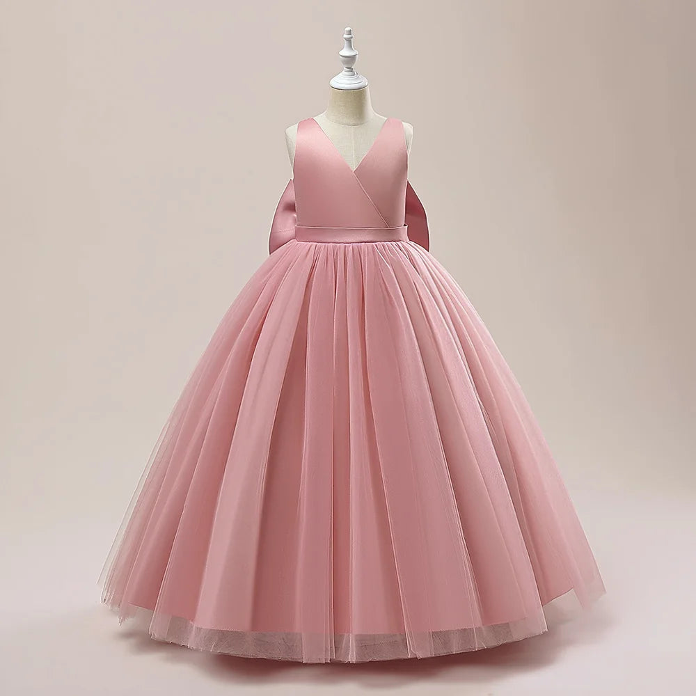 Girls white bridesmaid and prom gown with a big bow, formal evening dress, designed for weddings, parties, and communions.