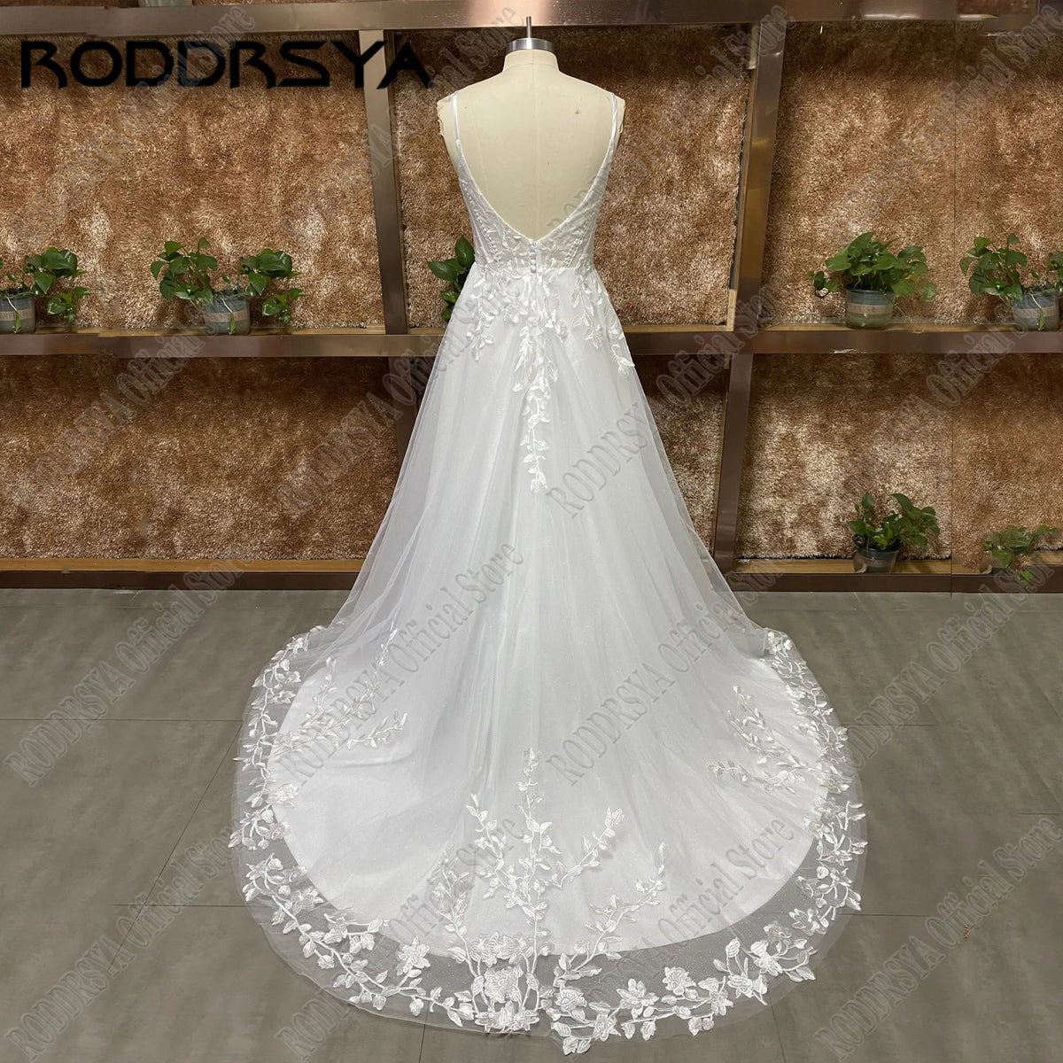 Glitter spaghetti strap wedding dress with V-neck, backless design, appliqué details, and sweep train by The Clothing Company Sydney.