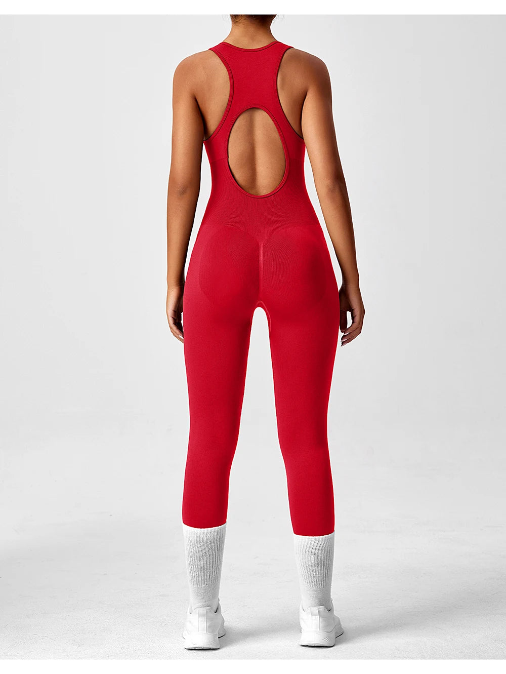 Seamless peach-colored women's one-piece yoga bodysuit with V-back design, from The Clothing Company Sydney, ideal for fitness and activewear.