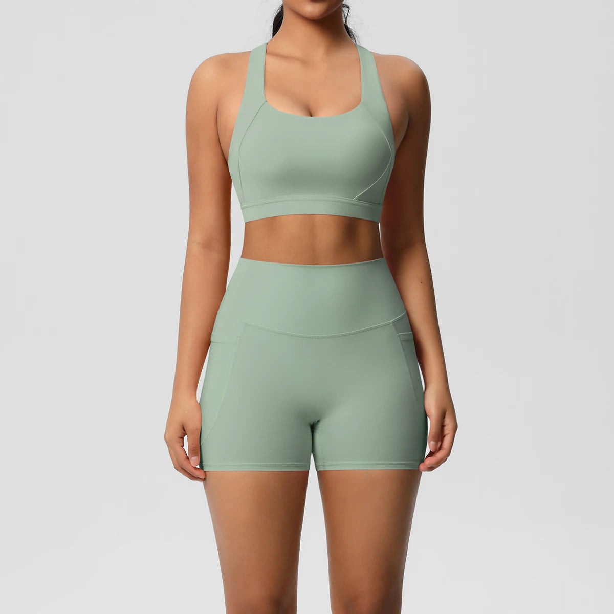 Women’s fitness sportswear set with pocketed gym clothes, crossover bra, leggings, and sports shorts by The Clothing Company Sydney.
