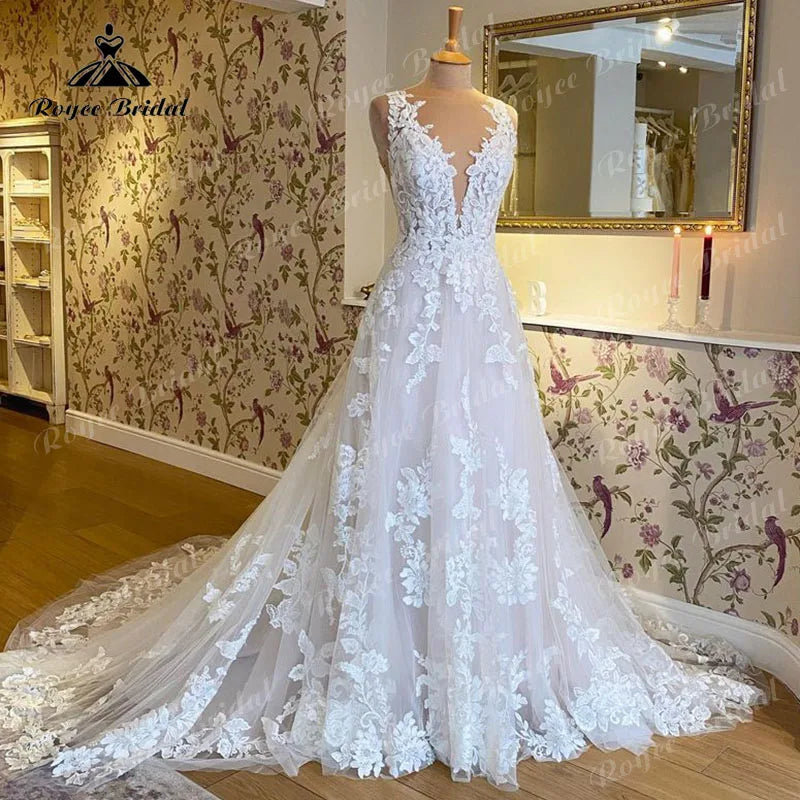 Blush pink sleeveless wedding dress by The Clothing Company Sydney with V-neck, lace applique, backless A-line bridal gown.