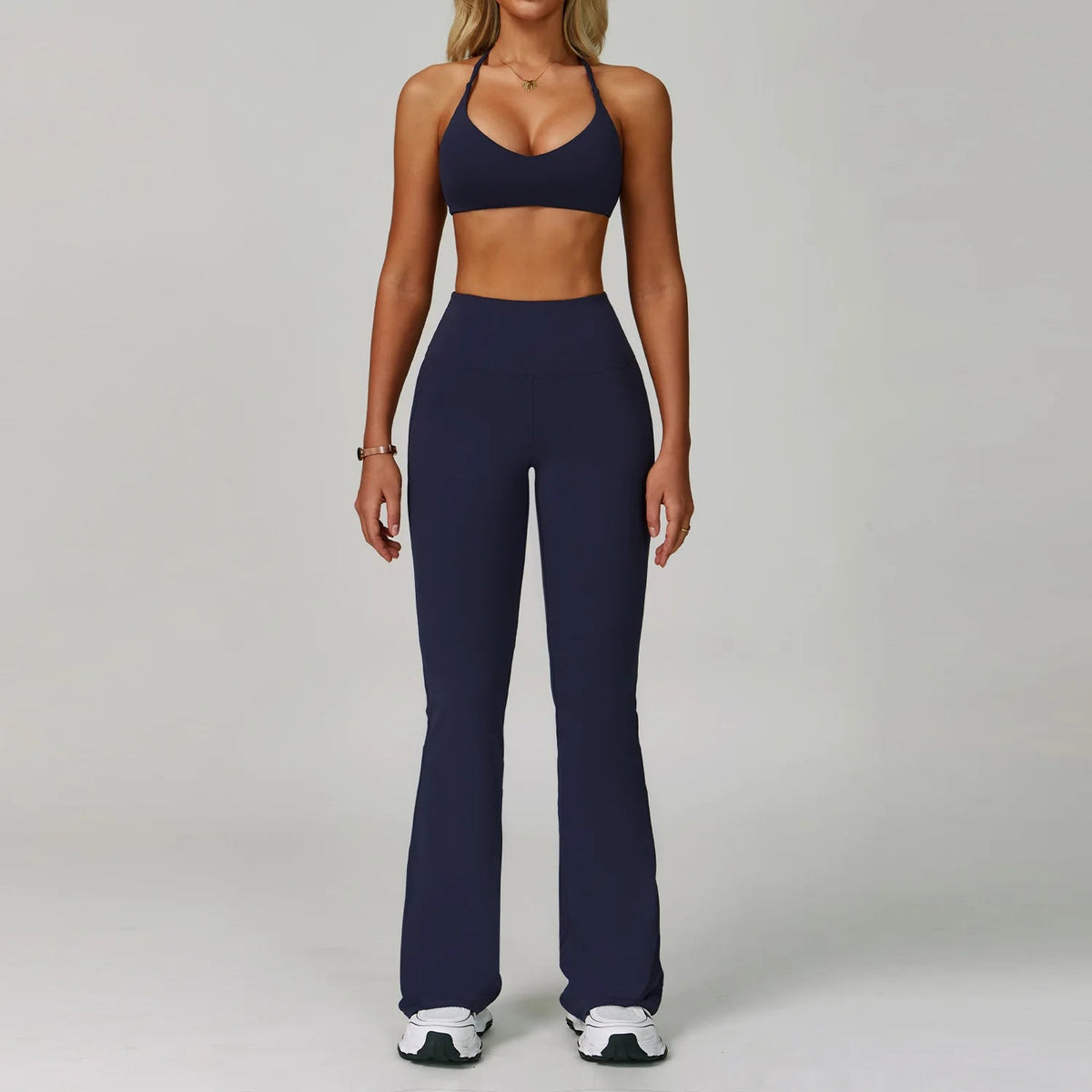 Women's fitness tracksuit set by The Clothing Company Sydney featuring high waist leggings and a matching sports bra for workout.