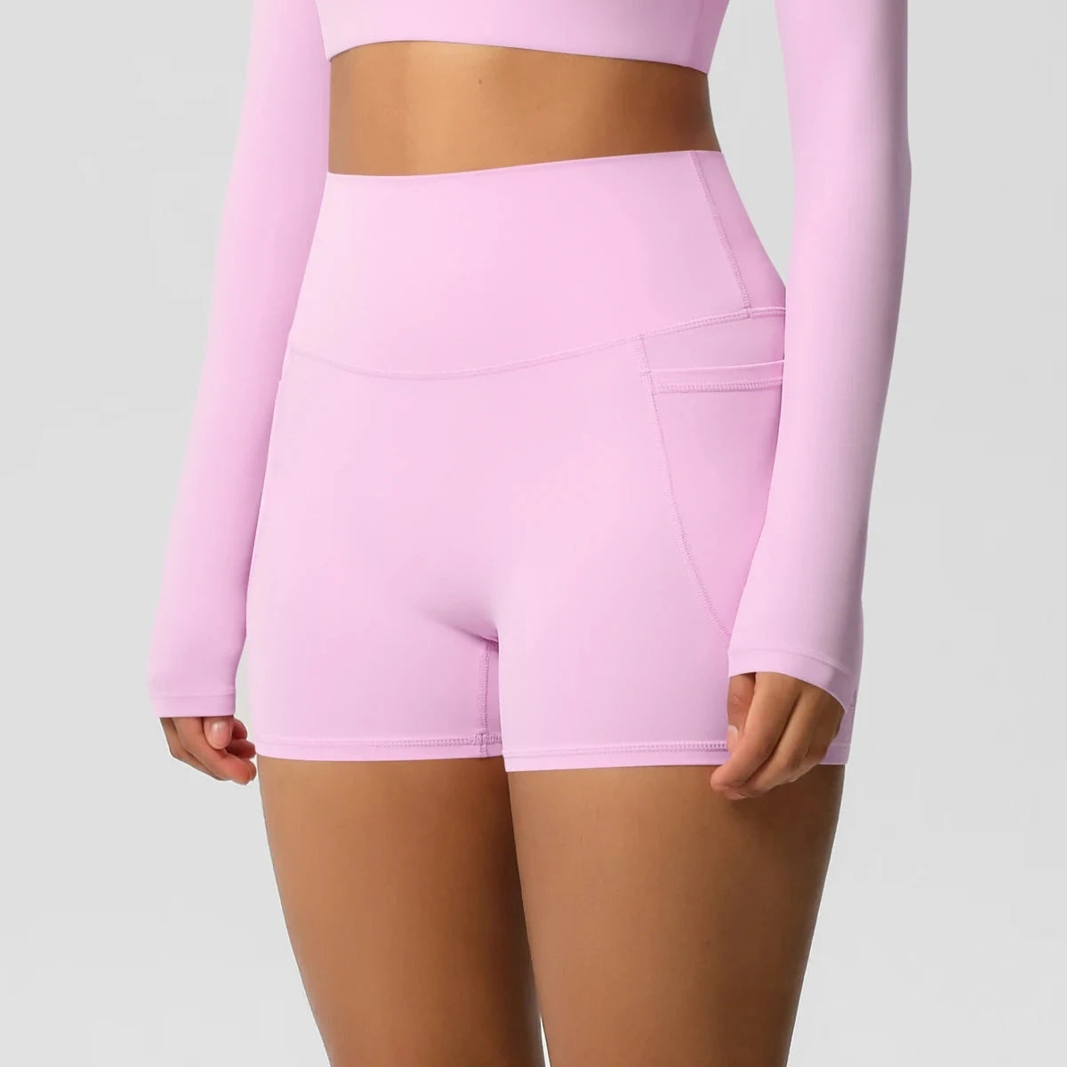 High-waisted bicycle yoga shorts with pockets, quick-drying, breathable fabric, designed for women’s gym and workout activities.